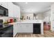 Well-lit kitchen showcasing white countertops, modern appliances, and wood-look flooring at 446 Deerfield Links Dr., Surfside Beach, SC 29575