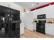 Bright kitchen featuring white cabinets, modern appliances, and red accent wall at 446 Deerfield Links Dr., Surfside Beach, SC 29575