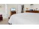 Bright main bedroom featuring white bedding and furniture with a television and ensuite bathroom at 446 Deerfield Links Dr., Surfside Beach, SC 29575