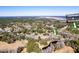 Scenic aerial view of a neighborhood with lush greenery and a community clubhouse and pond, offering natural beauty at 474 Wraggs Ferry Rd., Georgetown, SC 29440