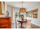 Elegant dining room featuring a round wood table, statement chandelier, and decoratively adorned walls at 474 Wraggs Ferry Rd., Georgetown, SC 29440