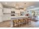 Open kitchen features white cabinets, a center island with seating, and stainless appliances at 474 Wraggs Ferry Rd., Georgetown, SC 29440