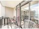 Enjoy outdoor relaxation on a private balcony with comfortable seating and views of the neighboring property at 4800 S Ocean Blvd. # 1514, North Myrtle Beach, SC 29582