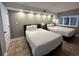 Bedroom with two beds, decorative lighting, and tile flooring at 4800 S Ocean Blvd. # 1514, North Myrtle Beach, SC 29582