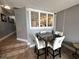 Dining area with a table, four chairs, and a window with blinds at 4800 S Ocean Blvd. # 1514, North Myrtle Beach, SC 29582