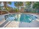 Inviting outdoor hot tub with clear blue water, a metal safety rail, and palm trees surrounding it at 4800 S Ocean Blvd. # 1514, North Myrtle Beach, SC 29582