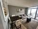 Cozy living room features neutral tones, access to balcony, modern design, and dining area for relaxed coastal living at 4800 S Ocean Blvd. # 1514, North Myrtle Beach, SC 29582