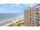 Stunning oceanfront views from the balcony of a high-rise building, overlooking a sandy beach and the expansive ocean at 4800 S Ocean Blvd. # 1514, North Myrtle Beach, SC 29582