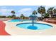 A relaxing outdoor pool area with a splash fountain surrounded by palm trees and poolside furniture at 4800 S Ocean Blvd. # 1514, North Myrtle Beach, SC 29582