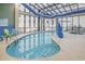 Bright indoor pool area with floor-to-ceiling windows and comfortable seating along the pool's edge at 4800 S Ocean Blvd. # 1514, North Myrtle Beach, SC 29582