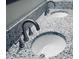 Close up on a bathroom vanity featuring a granite countertop and modern silver faucets at 4800 S Ocean Blvd. # 1614, North Myrtle Beach, SC 29582