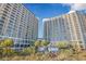 Beautiful exterior shot of modern high-rise condos with balconies, lush landscaping, and direct beach access at 4800 S Ocean Blvd. # 1614, North Myrtle Beach, SC 29582