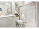 Well-lit bathroom featuring a white vanity and a shower with sliding glass doors at 4817 Magnolia Lake Dr. # 104, Myrtle Beach, SC 29577