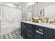 Modern bathroom featuring a double vanity with granite countertops and updated fixtures at 4817 Magnolia Lake Dr. # 104, Myrtle Beach, SC 29577