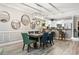 Dining room with a dining table set for six, bar seating overlooking a modern kitchen, and light wood flooring at 4817 Magnolia Lake Dr. # 104, Myrtle Beach, SC 29577