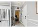 Home's entry with stainless steel refrigerator, decorative flooring, and a view into a bedroom with yellow accent wall at 4817 Magnolia Lake Dr. # 104, Myrtle Beach, SC 29577