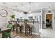 Kitchen with a granite bar top counter that leads into a dining area with green and blue chairs and a bedroom at 4817 Magnolia Lake Dr. # 104, Myrtle Beach, SC 29577