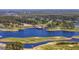 Picturesque aerial showcasing the golf course and clubhouse set on the edge of a pristine blue lake at 5060 Windsor Green Way # 304, Myrtle Beach, SC 29579