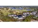 Aerial view of waterfront condos with lake, golf course, and mature trees at 5060 Windsor Green Way # 304, Myrtle Beach, SC 29579