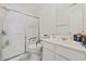 Bright bathroom featuring a sliding glass door shower and a white vanity with ample counter space at 5060 Windsor Green Way # 304, Myrtle Beach, SC 29579