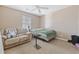 Cozy bedroom with a bed and tan-colored walls, complemented by a ceiling fan and natural light at 5060 Windsor Green Way # 304, Myrtle Beach, SC 29579