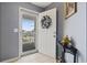 Inviting foyer with neutral tile flooring, a decorative wreath, and a glimpse of the outdoor scenery at 5060 Windsor Green Way # 304, Myrtle Beach, SC 29579