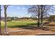 Scenic golf course with golfers on the green and trees, under a blue sky with scattered clouds at 5060 Windsor Green Way # 304, Myrtle Beach, SC 29579