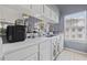 Galley kitchen with all white cabinets and countertops at 5060 Windsor Green Way # 304, Myrtle Beach, SC 29579