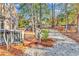 Outdoor space with wooden deck, lush trees, and gravel landscaping at 52 Olde Canal Loop, Pawleys Island, SC 29585