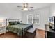 Bedroom with a ceiling fan and a cozy bed with olive green bedding and hardwood flooring at 52 Olde Canal Loop, Pawleys Island, SC 29585