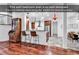 Kitchen and dining area with wood floors, bar seating, and stainless steel refrigerator at 52 Olde Canal Loop, Pawleys Island, SC 29585