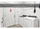 Bright laundry room features tile flooring and modern Whirlpool washer and dryer at 52 Olde Canal Loop, Pawleys Island, SC 29585