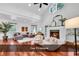 Bright living room featuring vaulted ceiling, fireplace, modern chairs, and cozy seating arrangement at 52 Olde Canal Loop, Pawleys Island, SC 29585