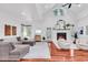 Bright living room featuring vaulted ceiling, fireplace, modern chairs, and cozy seating arrangement at 52 Olde Canal Loop, Pawleys Island, SC 29585