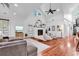 Bright living room featuring vaulted ceiling, fireplace, modern chairs, and cozy seating arrangement at 52 Olde Canal Loop, Pawleys Island, SC 29585