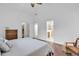 Open main bedroom with hardwood flooring leading to bathroom with glass-enclosed shower at 52 Olde Canal Loop, Pawleys Island, SC 29585