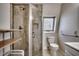 Tiled walk-in shower, modern fixtures, and natural light create a tranquil bathroom space at 547 South Waccamaw Dr., Garden City Beach, SC 29576