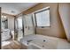 Bathroom featuring bathtub and shower combination, with a sink, toilet, and natural light at 547 South Waccamaw Dr., Garden City Beach, SC 29576