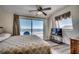 Bedroom with ocean view from sliding glass door, ceiling fan and accent lighting at 547 South Waccamaw Dr., Garden City Beach, SC 29576