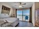 Bedroom with ocean view from sliding glass door leading to a balcony at 547 South Waccamaw Dr., Garden City Beach, SC 29576