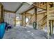 Spacious garage on stilts featuring stairs, wooden supports, and latticework at 547 South Waccamaw Dr., Garden City Beach, SC 29576