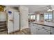 Open kitchen with stainless steel refrigerator and views of ocean through the open dining and living area at 547 South Waccamaw Dr., Garden City Beach, SC 29576