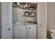 Laundry room features a washer, dryer, and shelving for ample storage at 547 South Waccamaw Dr., Garden City Beach, SC 29576