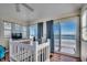 Open loft space leading to a balcony, wood floors, and natural light at 547 South Waccamaw Dr., Garden City Beach, SC 29576