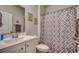 Well-lit bathroom with a shower, decorative artwork, and a white sink at 583 Meadowgrass Ct., Myrtle Beach, SC 29588