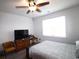 Bright bedroom featuring a ceiling fan and a large window for natural light at 583 Meadowgrass Ct., Myrtle Beach, SC 29588