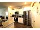 Well-equipped kitchen with stainless steel refrigerator, white cabinetry, and granite counters at 583 Meadowgrass Ct., Myrtle Beach, SC 29588