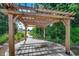 Wooden pergola over a concrete pad with a stone path leading into a garden area at 583 Meadowgrass Ct., Myrtle Beach, SC 29588