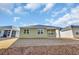 Wide view of the backyard with green siding at 609 Gryffindor Dr., Longs, SC 29568