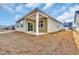 View of new backyard with green siding and patio at 609 Gryffindor Dr., Longs, SC 29568